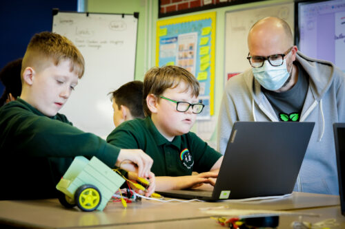 Two learners and a teacher in a physical computing lesson.